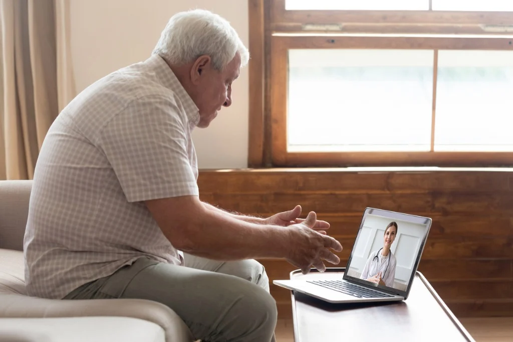 elderly man make distant video call communicating with doctor online picture id1182248151